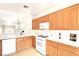 Bright and airy kitchen featuring white countertops, wood cabinets, and a view into the adjacent room at 8120 Backpacker Ct, Las Vegas, NV 89131