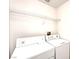 Functional laundry room with a washer, dryer, and shelving for storage, making laundry chores a breeze at 8120 Backpacker Ct, Las Vegas, NV 89131