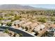 Wide aerial shot featuring a neighborhood with manicured lawns, solar panels, and desert landscape at 8180 Loma Del Ray St, Las Vegas, NV 89131