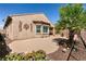 A cozy backyard featuring a patio, mature landscaping, and elegant stucco walls at 8180 Loma Del Ray St, Las Vegas, NV 89131