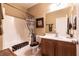 Bathroom featuring shower-tub combo with tile surround and single sink vanity at 8180 Loma Del Ray St, Las Vegas, NV 89131
