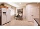Charming breakfast nook with a cozy table set, white appliances, and shuttered windows at 8180 Loma Del Ray St, Las Vegas, NV 89131