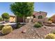 Desert landscape with barrel cactus, decorative rock, wrought iron gate, and mature landscaping at 8180 Loma Del Ray St, Las Vegas, NV 89131