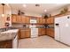 Charming kitchen with wooden cabinets, granite countertops, and modern appliances at 8180 Loma Del Ray St, Las Vegas, NV 89131