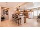 Well-lit kitchen with a breakfast bar, tile floors, stainless appliances, and ample cabinet space at 8180 Loma Del Ray St, Las Vegas, NV 89131