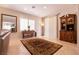 Bright living room featuring window shutters, tile flooring, and a classic display cabinet at 8180 Loma Del Ray St, Las Vegas, NV 89131