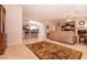 Open living area with tile flooring, decorative rug, and seamless flow to kitchen and dining at 8180 Loma Del Ray St, Las Vegas, NV 89131