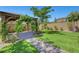Spacious backyard featuring lush artificial turf, a stone pathway, and a pergola perfect for outdoor gatherings at 8349 Pollenzo Ave, Las Vegas, NV 89178