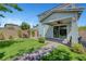 Well-maintained backyard featuring artificial turf, patio with ceiling fan, and a brick pathway to the home at 8349 Pollenzo Ave, Las Vegas, NV 89178
