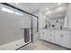 Modern bathroom with double sinks, a large mirror, and a glass-enclosed shower at 8349 Pollenzo Ave, Las Vegas, NV 89178