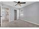 Carpeted bedroom with ceiling fan, closet, and ensuite bathroom for added convenience at 8349 Pollenzo Ave, Las Vegas, NV 89178