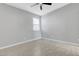 Bright bedroom featuring neutral walls, wood-look flooring, and a ceiling fan at 8349 Pollenzo Ave, Las Vegas, NV 89178