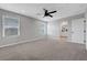 Carpeted bedroom featuring a ceiling fan and bathroom access at 8349 Pollenzo Ave, Las Vegas, NV 89178