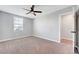 Well-lit carpeted bedroom with a ceiling fan and a view from the window at 8349 Pollenzo Ave, Las Vegas, NV 89178