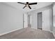 Bedroom with carpet, ceiling fan, and an open closet with sliding doors at 8349 Pollenzo Ave, Las Vegas, NV 89178