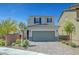 Charming two-story home with a paved driveway, a two-car garage, and manicured landscaping at 8349 Pollenzo Ave, Las Vegas, NV 89178