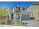 Inviting two-story home with a paved walkway, manicured landscaping, and attached garage at 8349 Pollenzo Ave, Las Vegas, NV 89178