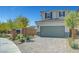 A well-maintained home front, showcasing a two-car garage and a professionally landscaped yard with a for sale sign at 8349 Pollenzo Ave, Las Vegas, NV 89178