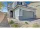 Charming home exterior with a neat walkway, complemented by a grey two car garage at 8349 Pollenzo Ave, Las Vegas, NV 89178