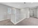 Carpeted hallway with staircase featuring white railing at 8349 Pollenzo Ave, Las Vegas, NV 89178