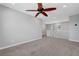 Carpeted hallway with white railings, ceiling fan, and natural light at 8349 Pollenzo Ave, Las Vegas, NV 89178