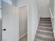 Hallway and carpeted staircase with a storage space and neutral color palette at 8349 Pollenzo Ave, Las Vegas, NV 89178