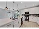 Contemporary kitchen with a large island, stainless steel appliances, and stylish pendant lighting at 8349 Pollenzo Ave, Las Vegas, NV 89178