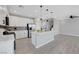 Modern kitchen featuring white cabinets, stainless steel appliances, a center island and open to the living area at 8349 Pollenzo Ave, Las Vegas, NV 89178