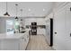 Modern kitchen featuring sleek appliances, a center island, and access to the outdoor patio at 8349 Pollenzo Ave, Las Vegas, NV 89178