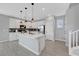 Bright kitchen featuring white cabinets, pendant lighting, stainless steel appliances, and a large center island at 8349 Pollenzo Ave, Las Vegas, NV 89178