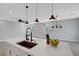Modern kitchen island with white countertop, stainless steel sink, and pendant lighting at 8349 Pollenzo Ave, Las Vegas, NV 89178