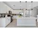 Well-lit kitchen featuring white cabinets, stainless steel appliances, and a spacious center island at 8349 Pollenzo Ave, Las Vegas, NV 89178