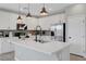 Bright kitchen with white cabinetry, stainless steel appliances, and a large island with quartz countertops at 8349 Pollenzo Ave, Las Vegas, NV 89178