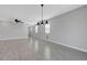 Bright living room with grey walls, tiled floors, and modern lighting fixtures at 8349 Pollenzo Ave, Las Vegas, NV 89178