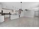 Open floor plan featuring tile flooring, kitchen island, and adjacent staircase at 8349 Pollenzo Ave, Las Vegas, NV 89178