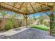 Inside of pergola featuring a stone base and climbing vines on a sunny day, perfect for outdoor gatherings at 8349 Pollenzo Ave, Las Vegas, NV 89178