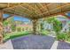 View from inside the pergola to the yard with climbing vines and brick pavers, creating a tranquil outdoor area at 8349 Pollenzo Ave, Las Vegas, NV 89178