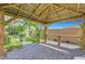 View under pergola, with beautiful stone base and verdant climbing vines, creating a serene outdoor living space at 8349 Pollenzo Ave, Las Vegas, NV 89178