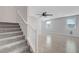 A carpeted staircase leading to a living room with wood-look floors at 8349 Pollenzo Ave, Las Vegas, NV 89178