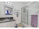 Clean bathroom with updated vanity, mirror, and shower-tub combo with glass doors at 8410 Eldora Ave # 2082, Las Vegas, NV 89117