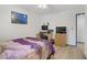 Bedroom featuring an office space, neutral decor, and adjoining door to hallway at 8410 Eldora Ave # 2082, Las Vegas, NV 89117