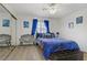 Comfortable bedroom with a mirrored closet, a stylish bed with blue bedding, and decorative chairs at 8410 Eldora Ave # 2082, Las Vegas, NV 89117