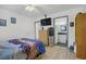 Comfortable bedroom with dresser, TV, mirrored closet and view to an ensuite bathroom at 8410 Eldora Ave # 2082, Las Vegas, NV 89117