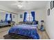 Comfortable bedroom with a mirrored closet, a stylish bed with blue bedding, and a bench at 8410 Eldora Ave # 2082, Las Vegas, NV 89117
