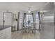 Dining area featuring a glass table, bright natural light, and stainless steel refrigerator at 8410 Eldora Ave # 2082, Las Vegas, NV 89117