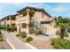 Exterior of a tan two-story condo with desert landscaping,stairs to the entrance, and a view of the sky at 8410 Eldora Ave # 2082, Las Vegas, NV 89117