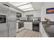 Bright kitchen featuring a stainless steel refrigerator, white cabinets, and an open plan layout at 8410 Eldora Ave # 2082, Las Vegas, NV 89117