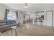 Bright living room with modern furnishings, light wood floors and a view to the open kitchen at 8410 Eldora Ave # 2082, Las Vegas, NV 89117