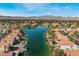 Aerial view of a lakeside community surrounded by mountains at 8640 Portofino Ct, Las Vegas, NV 89117