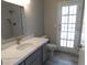 Bathroom with modern vanity, quartz countertop, and grey walls at 8640 Portofino Ct, Las Vegas, NV 89117